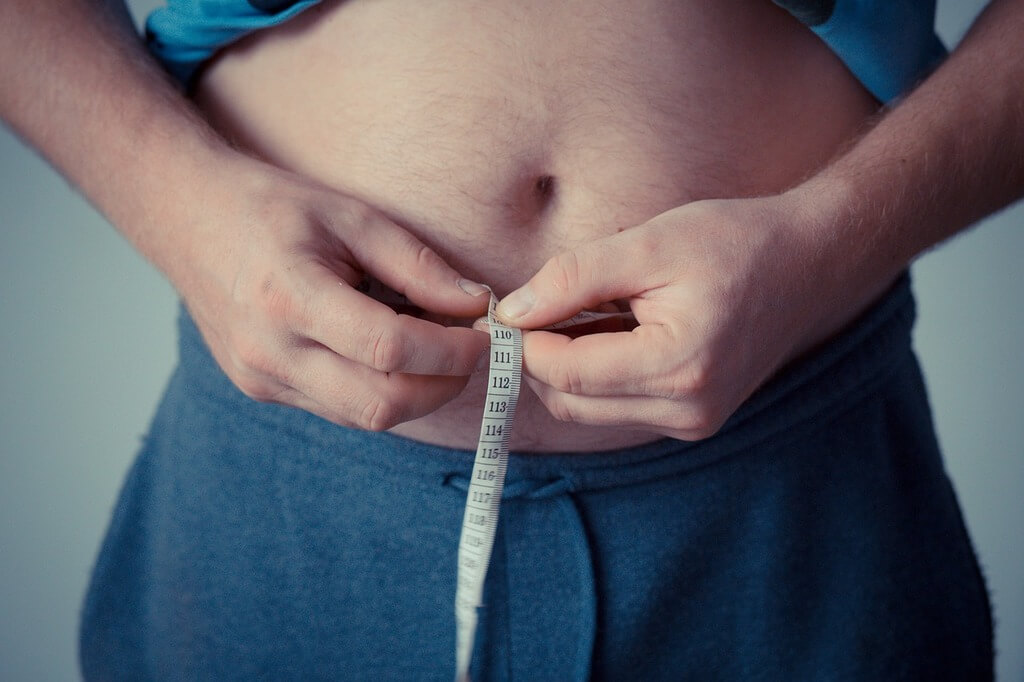 Home mesurant son tour de taille - prise de poids et spondylarthrite ankylosante